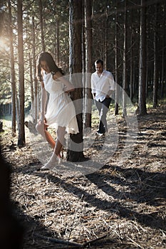 Young handsome Indian couple spending afternoon in forest