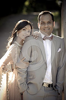 Young handsome Indian couple standing together outdoors