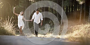 Young handsome Indian couple walking through field