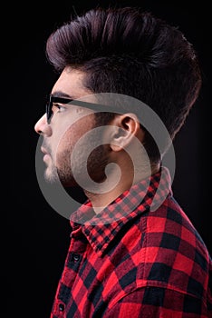 Young handsome Indian man against black background