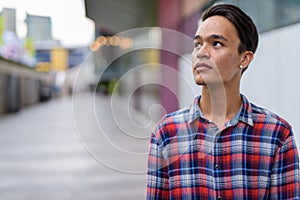 Young handsome Indian man exploring the city of Bangkok, Thailan