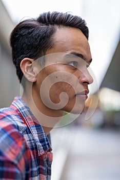 Young handsome Indian man exploring the city of Bangkok, Thailan