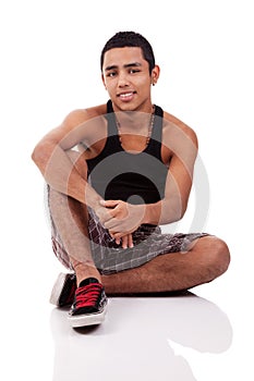 Young and handsome latin man, seated on floor photo