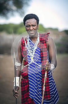 Young, handsome Maasai man in his traditional outfit