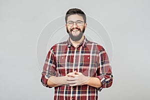 Young handsome male with beard against gray background