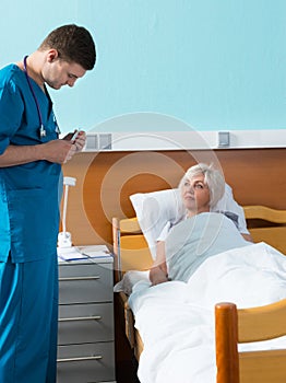 Young handsome male doctor in uniform with phonendoscope on his