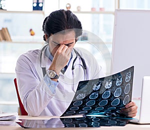 Young handsome male radiologist in front of whiteboard