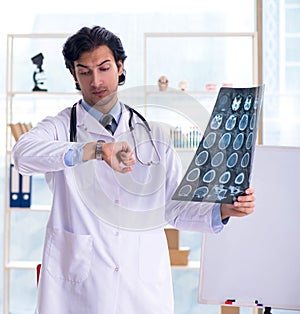 Young handsome male radiologist in front of whiteboard