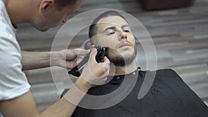 Young handsome man in barbershop