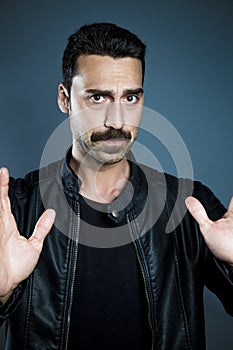 Young handsome man with beard and mustache studio portrait