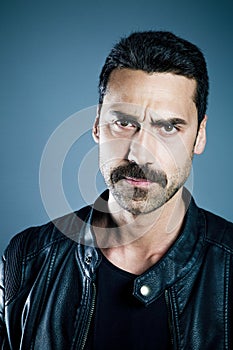 Young handsome man with beard and mustache studio portrait