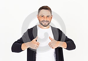 Young handsome man with beard wearing casual clothes on a white background, approving doing positive gesture with hand, thumbs up photo