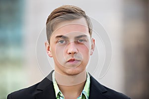 Young handsome man in black blazer walking on street