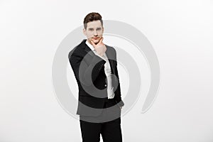 Young handsome man in black suit and glasses looking at copy-space thinking or dreaming isolated over white background