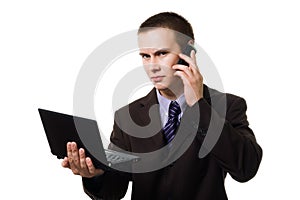 Young handsome man with cell phone and laptop