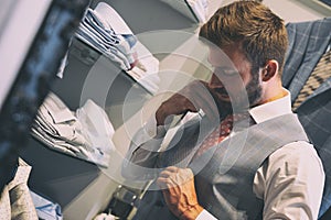 Young handsome man choosing ties, choosing neckties