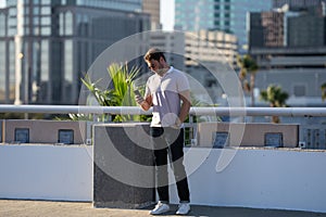 Young handsome man in classik polo t-shirt on the street. Handsome confident stylish hipster model posing outside. Sexy