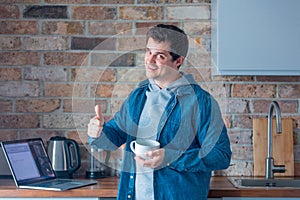 Young handsome man cooking at kitchen