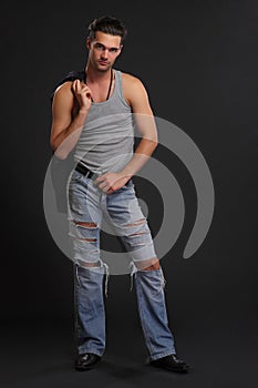 Young handsome man in a dark studio