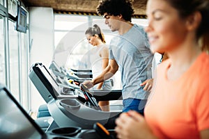 Young handsome man doing cardio training in gym