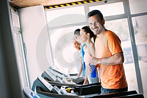 Young handsome man doing cardio training in gym