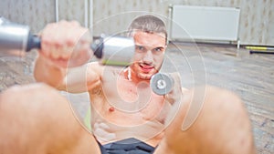 Young handsome man doing a curl for abdominals