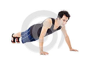 Young handsome man doing push up exercise