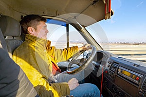 Young handsome man driving a truck