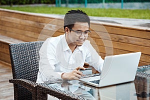 Young Handsome man enjoy shopping online on mobile phone with cr