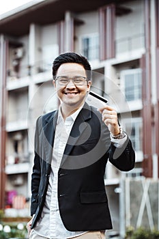 Young Handsome man enjoy shopping online on mobile phone with cr
