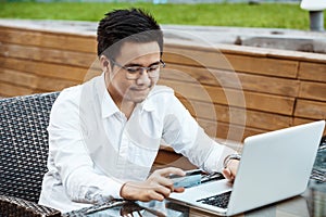 Young Handsome man enjoy shopping online on mobile phone with credit card