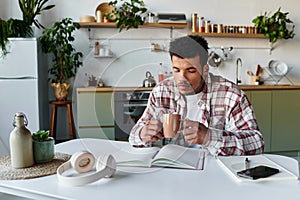 Young handsome man enjoying coffee while