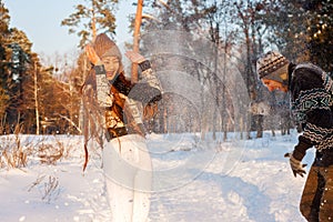 A young handsome man of European appearance and a young Asian girl in a park on the nature in winter