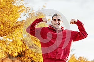 Young handsome man flexing mucles outdoor