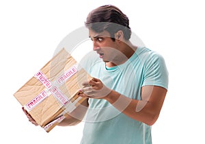 Young handsome man with fragile box ordered from Internet
