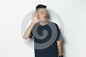 Young handsome man with hand over ear listening an hearing to gossip isolated on white background