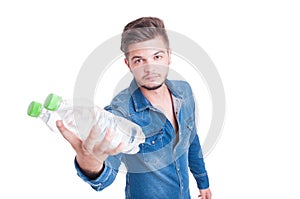 Young handsome man handing two bottles of cold water