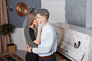 Young handsome man with a happy girlfriend in elegant clothes