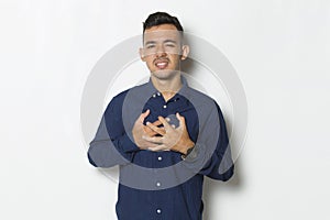 Young handsome man having heart attack isolated on white background