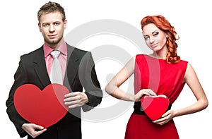 Young handsome man holding red heart and cheerful woman on white