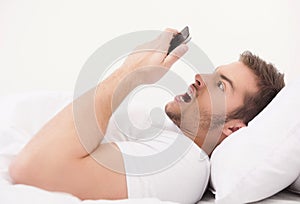 Young handsome man holding telephone.