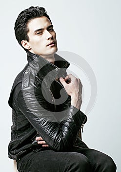 Young handsome man, leather jacked on naked torso, emotional posing, white background, modern guy, lifestyle people