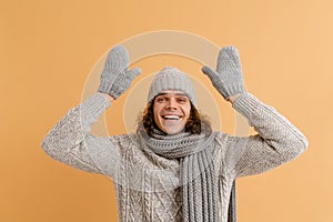 Young handsome man with long hair in winter hat