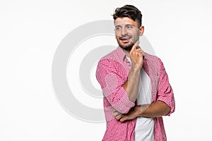 Young handsome man making a wish isolated on white background