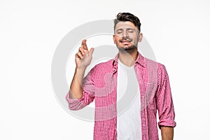 Young handsome man making a wish isolated on white background