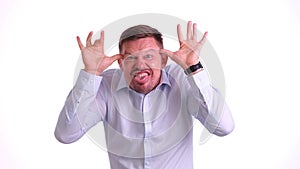 Young handsome man over isolated background making crazy and funny gesture