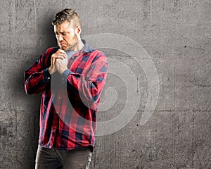 Young handsome man over wall background