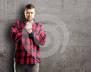 Young handsome man over wall background