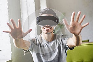 Young handsome man playing video games in smart 3d tech at home