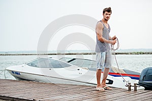 Young handsome man preparing boat to start a journey